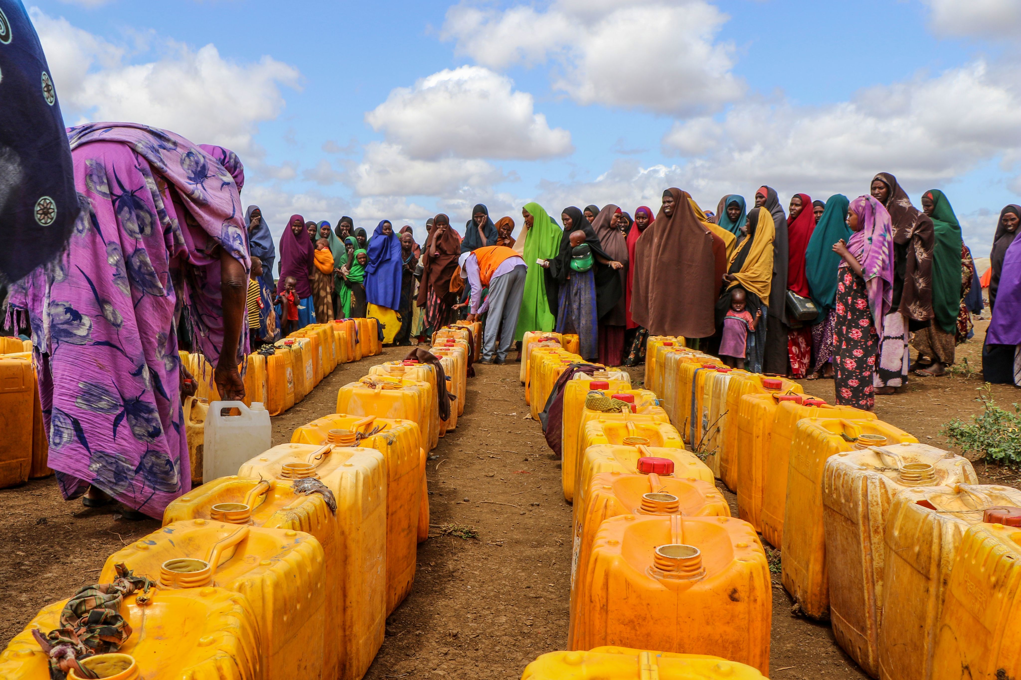 Women queue to collect water at Kaam Jiroon internally displaced persons camp for people uprooted by drought in Baidoa, Somalia. ©Abdulkadir Mohamed/NRC