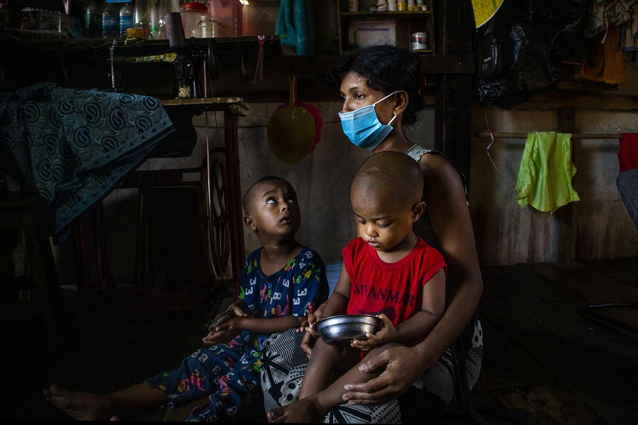 Ma Nilar Than and her two sons at their home, Hlaing Thar Yar Township, Myanmar. ©UNICEF/UN0556781/Nyan Zay Htet